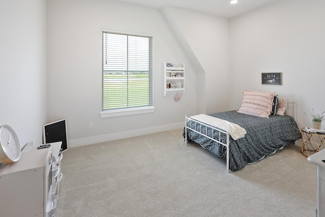 carpeted bedroom with vaulted ceiling