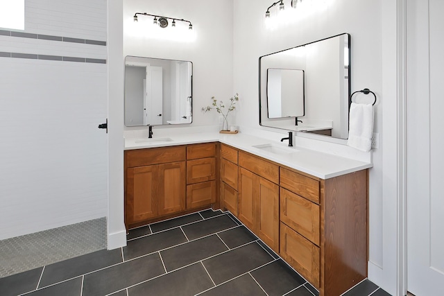 bathroom with tile patterned floors, vanity, and a shower