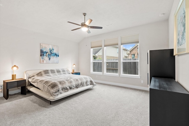 carpeted bedroom featuring a ceiling fan, visible vents, vaulted ceiling, and baseboards