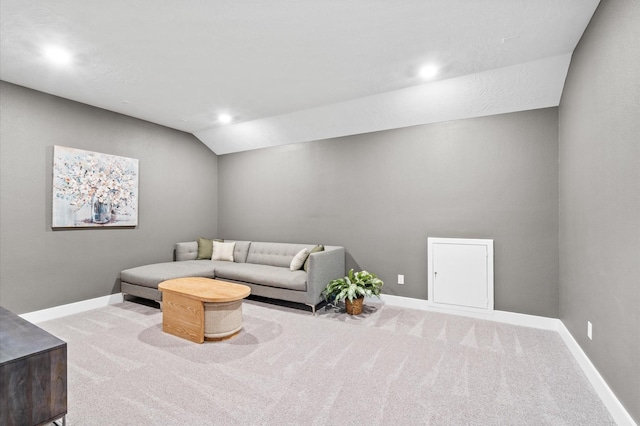 living room with carpet, vaulted ceiling, and baseboards