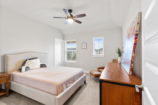 bedroom featuring light carpet, lofted ceiling, a ceiling fan, and baseboards