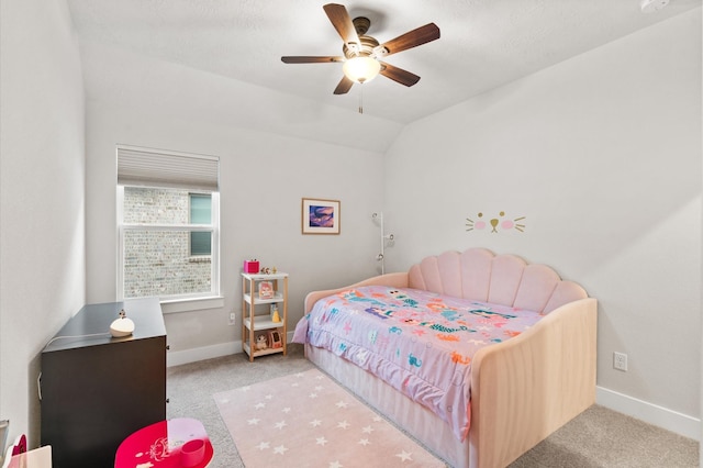 carpeted bedroom with vaulted ceiling, ceiling fan, and baseboards