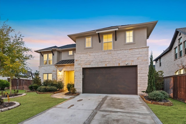 view of front of home featuring a lawn and a garage