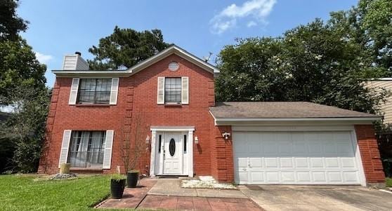 view of front facade with a garage and a front yard