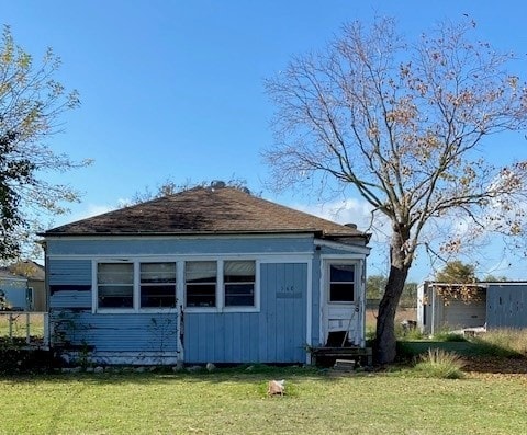 rear view of house with a yard