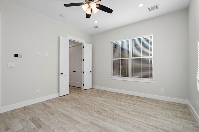 unfurnished bedroom with ceiling fan and light hardwood / wood-style flooring