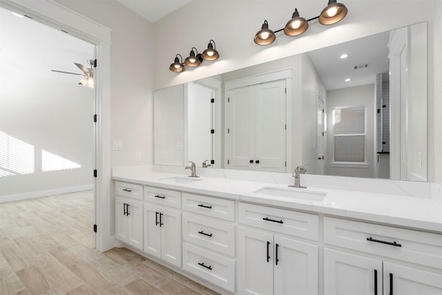 bathroom with ceiling fan, hardwood / wood-style floors, and vanity