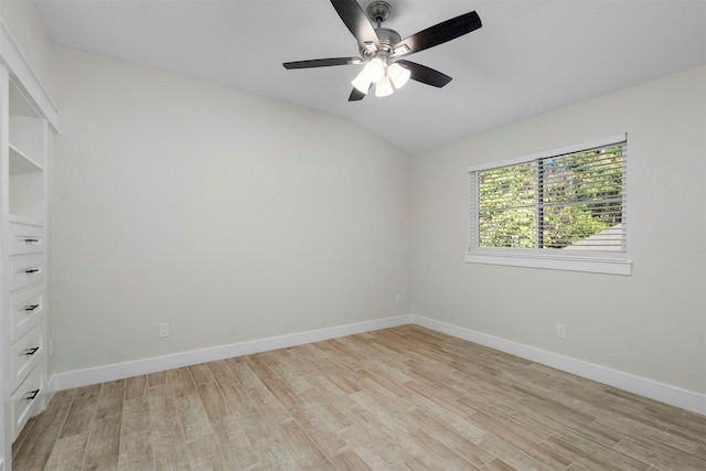 spare room with ceiling fan, light hardwood / wood-style floors, and vaulted ceiling