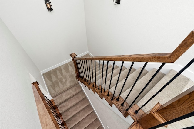 staircase with wood-type flooring