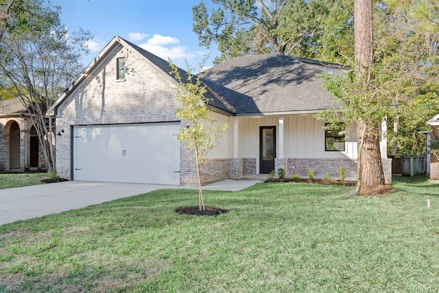 view of front of property with a front yard and a garage