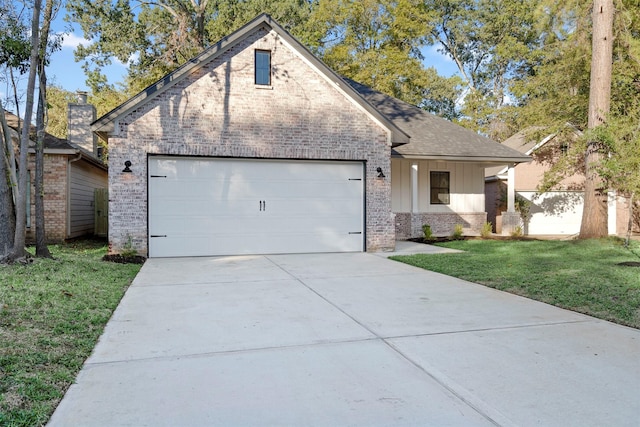 view of front of home with a front yard and a garage