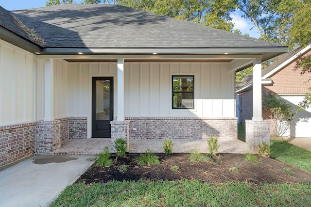 view of exterior entry with a porch