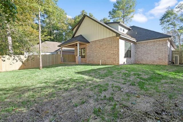 rear view of house featuring a yard