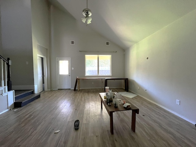 unfurnished living room featuring hardwood / wood-style flooring and high vaulted ceiling