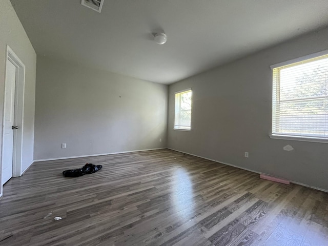 unfurnished room with dark hardwood / wood-style flooring