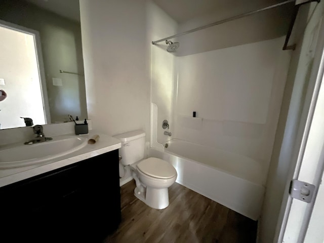 full bathroom with hardwood / wood-style flooring, vanity, toilet, and shower / tub combination