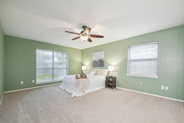 unfurnished bedroom with carpet floors, baseboards, and a ceiling fan