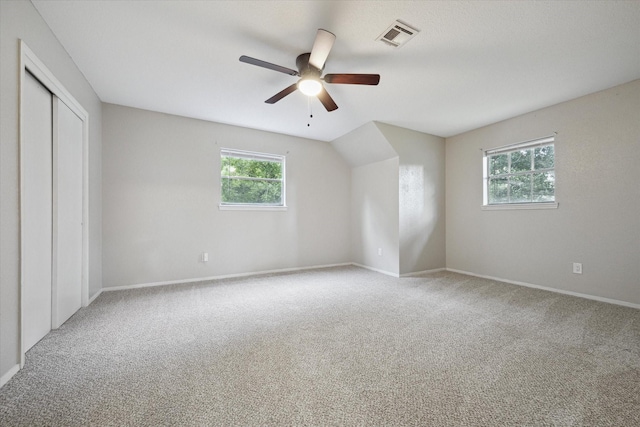 unfurnished bedroom with baseboards, visible vents, a ceiling fan, carpet floors, and a closet