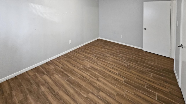 empty room with dark hardwood / wood-style floors