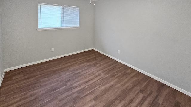 spare room featuring dark wood-type flooring