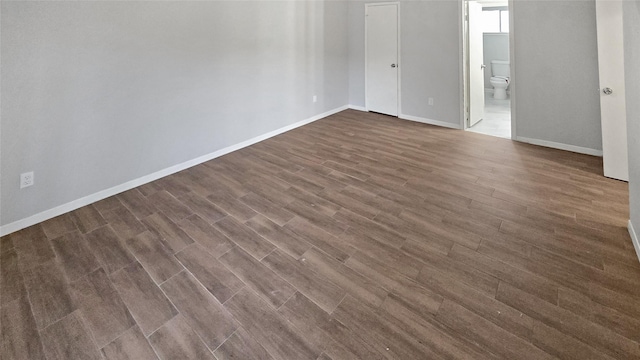 spare room featuring dark hardwood / wood-style flooring