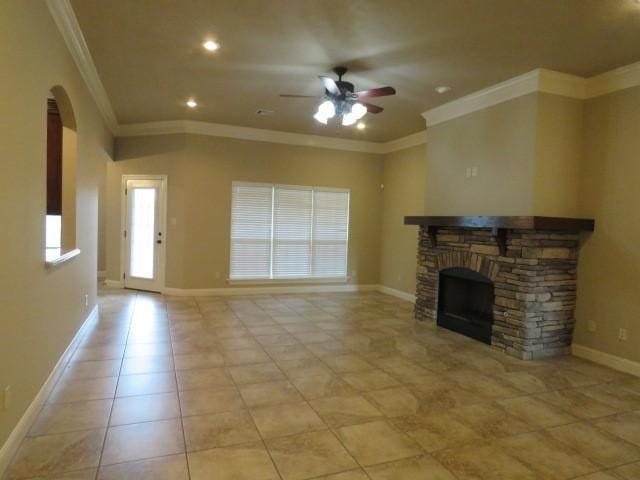 unfurnished living room featuring a stone fireplace, ceiling fan, crown molding, and light tile patterned floors