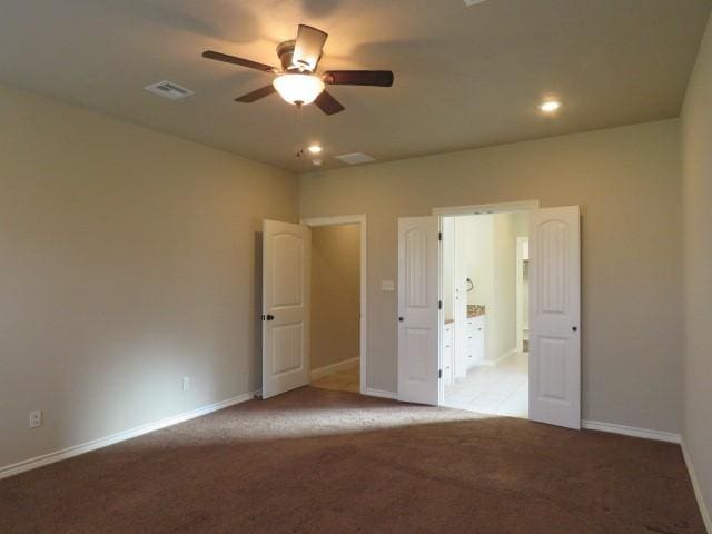 unfurnished bedroom featuring ceiling fan and light carpet