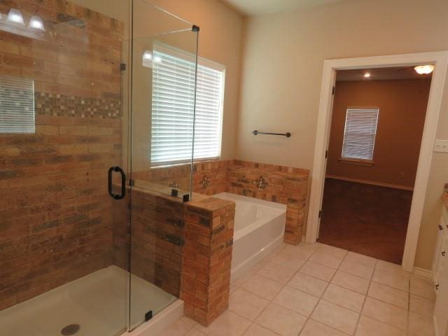 bathroom featuring tile patterned floors, vanity, and plus walk in shower