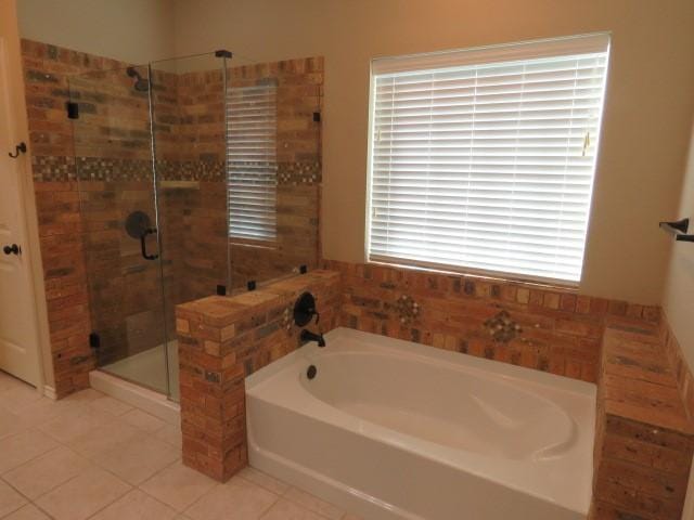 bathroom featuring tile patterned flooring and separate shower and tub