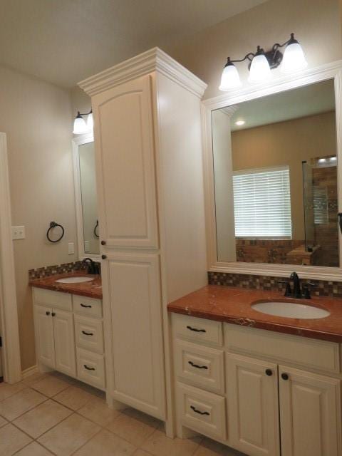 bathroom featuring tile patterned floors, vanity, and an enclosed shower