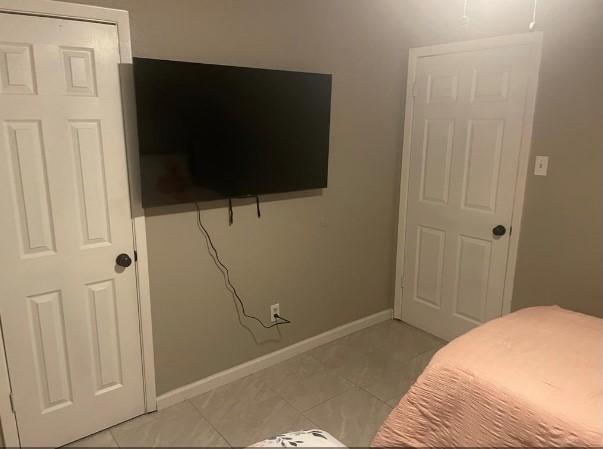 bedroom featuring light tile patterned flooring