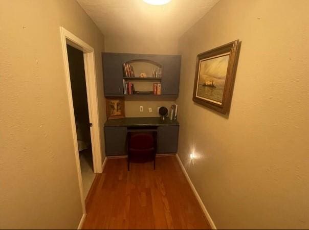 hallway with dark hardwood / wood-style floors