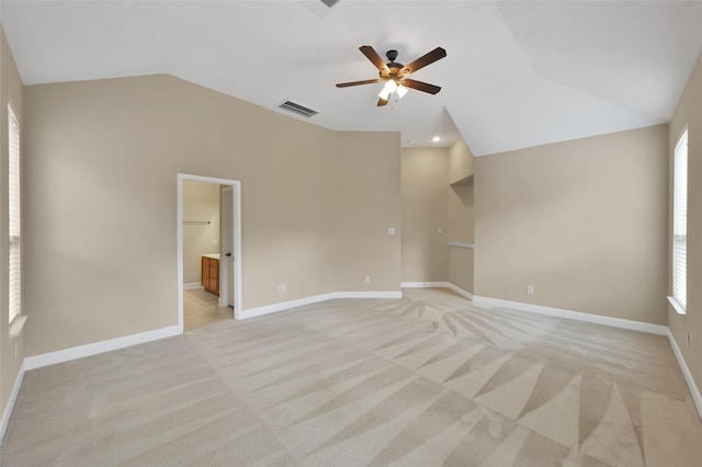 spare room with light colored carpet, plenty of natural light, lofted ceiling, and ceiling fan