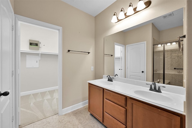 bathroom featuring tile patterned floors, vanity, and an enclosed shower