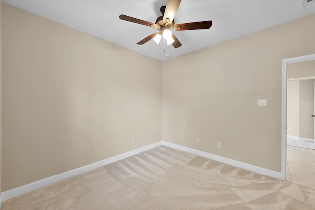 carpeted spare room featuring ceiling fan