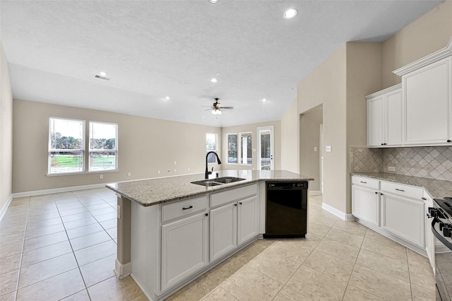 kitchen with light stone counters, sink, a center island with sink, and black dishwasher