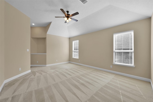 carpeted empty room with vaulted ceiling and ceiling fan