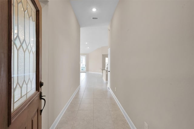 hall featuring light tile patterned floors