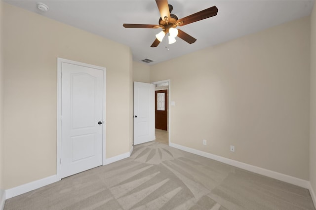 unfurnished bedroom with light carpet and ceiling fan