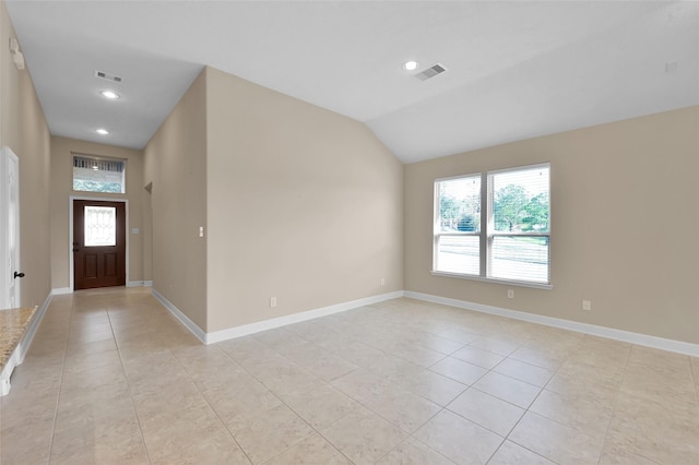 tiled entrance foyer featuring lofted ceiling