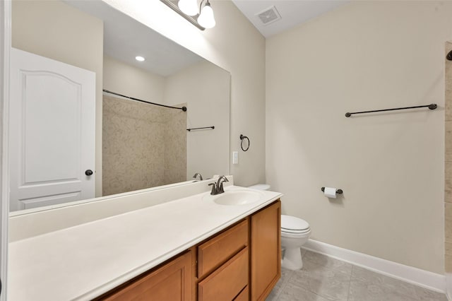 bathroom featuring tile patterned flooring, vanity, and toilet