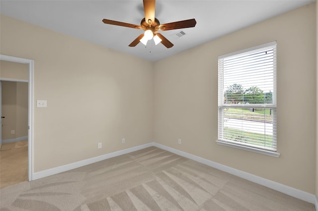 carpeted empty room featuring ceiling fan