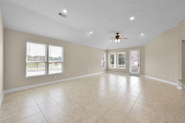 spare room with ceiling fan and light tile patterned floors