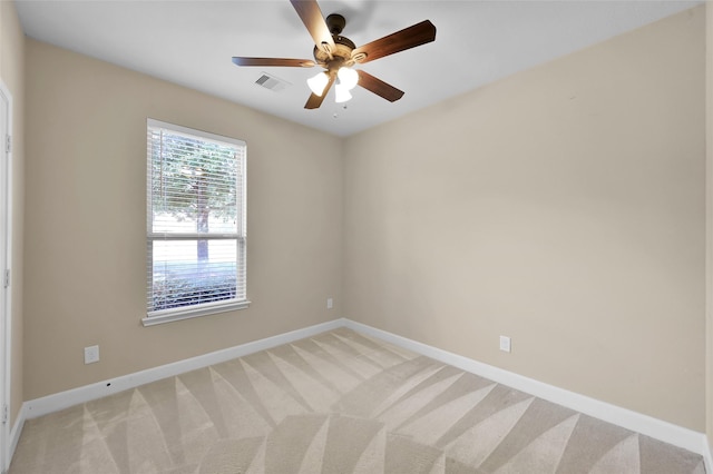 spare room featuring carpet and ceiling fan