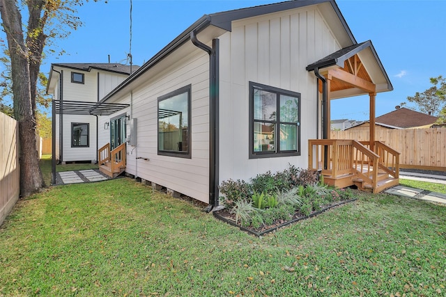 rear view of property with a yard