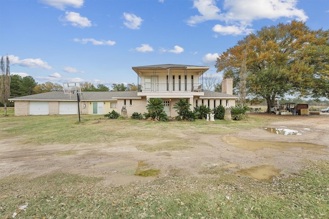 back of house featuring a balcony