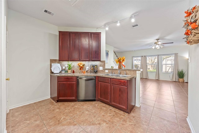 kitchen with dishwasher, sink, ceiling fan, light tile patterned floors, and tasteful backsplash