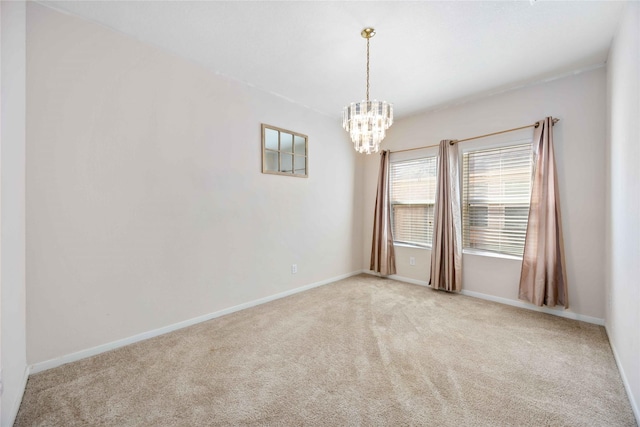 unfurnished room with light colored carpet and an inviting chandelier