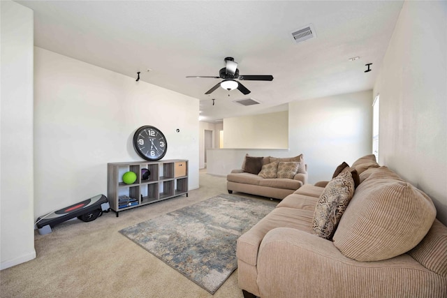 living room with ceiling fan and light colored carpet