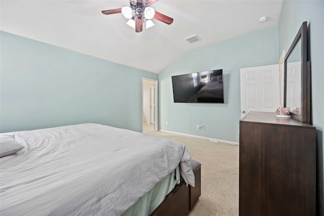 bedroom featuring ceiling fan, light colored carpet, and vaulted ceiling